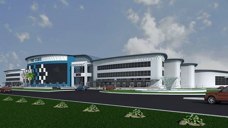 Daytime architectural rendering of a large retail complex with a blue curved facade